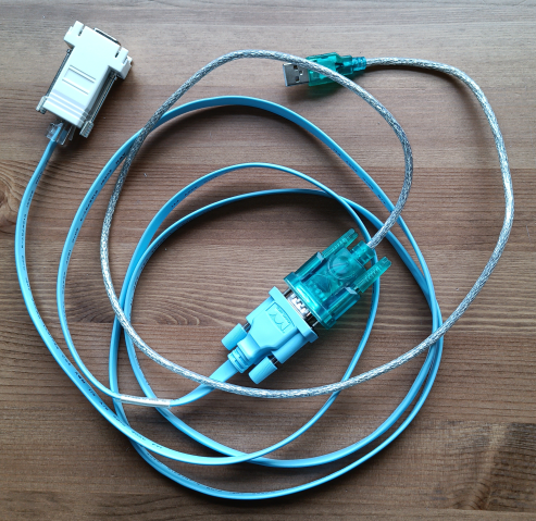 Photo of usb-to-serial adapter, a blue Cisco RJ45-to-DB9 cable and a crossed RJ45-to-DB9 adapter